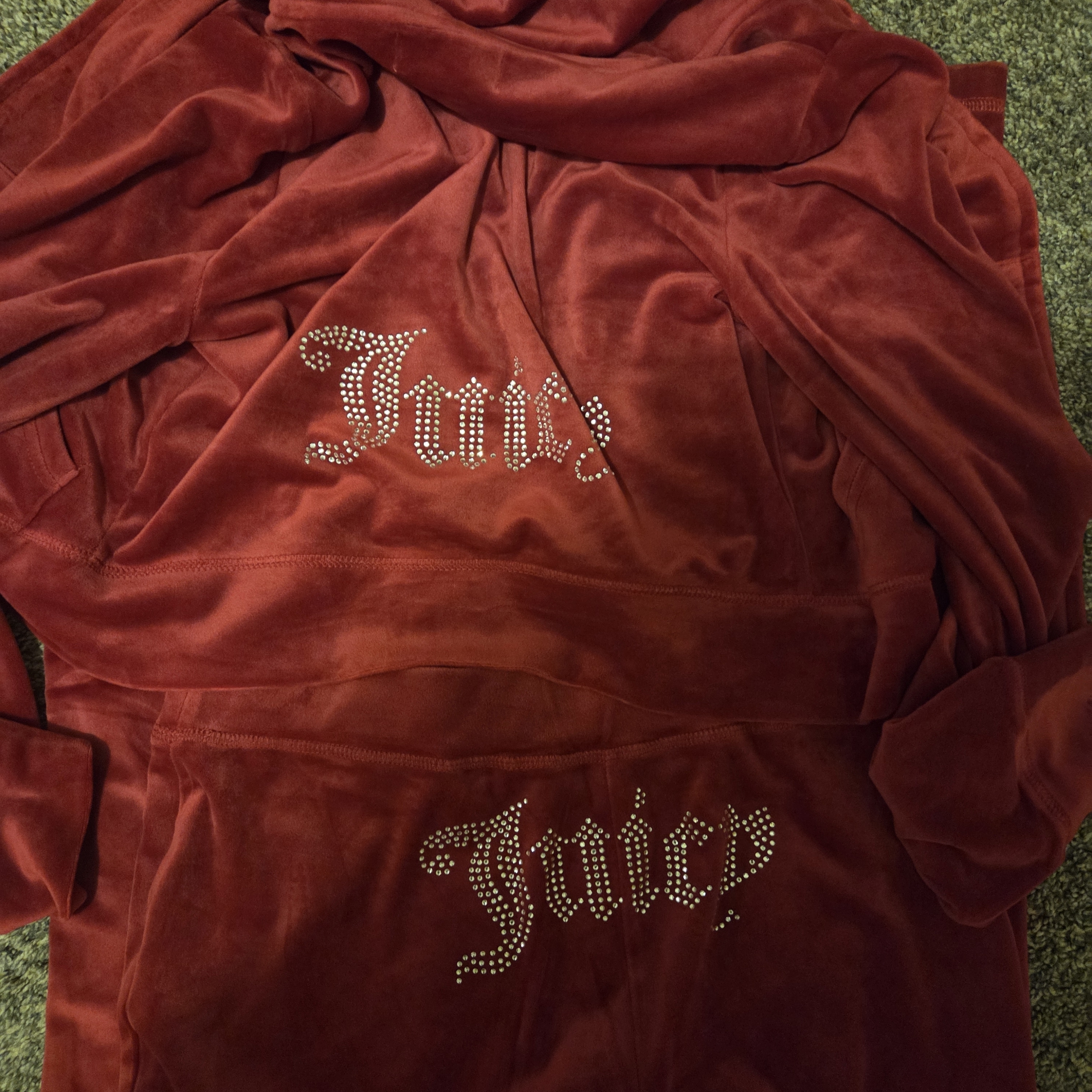 Deep red Juicy Couture velour tracksuit with the Juicy wordmark in crystals on the chest and hood